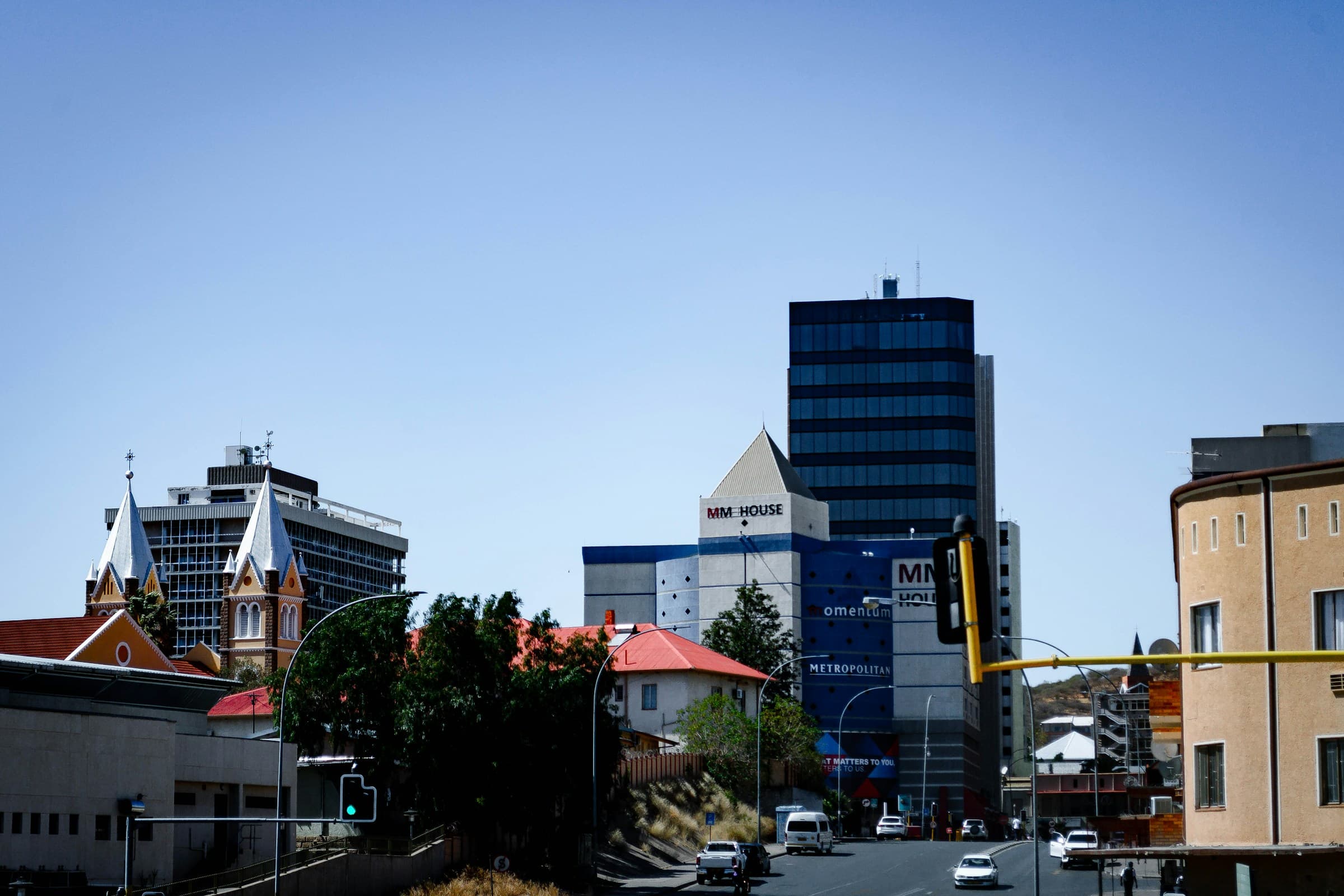 A street in Windhoek with city buildings and everyday traffic